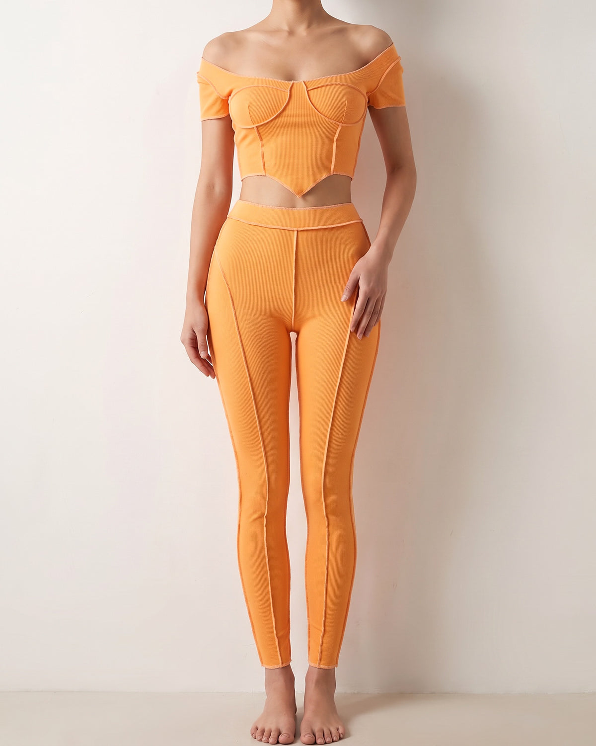 Orange ribbed set with reverse overlock stitch detail, alternate front view on model