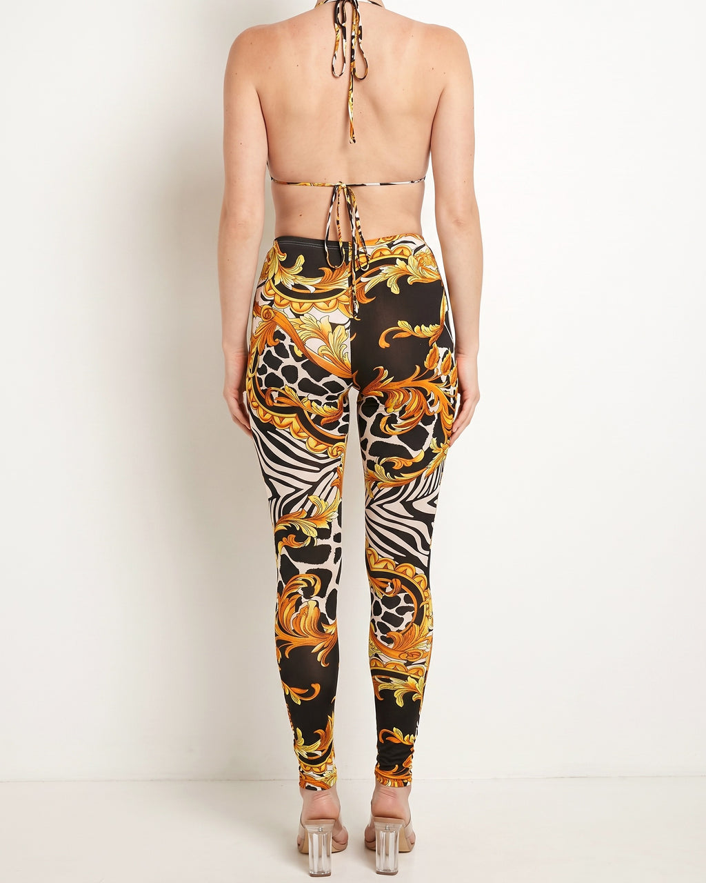 Black yellow o ring detailed halter neck jumpsuit, back view on model