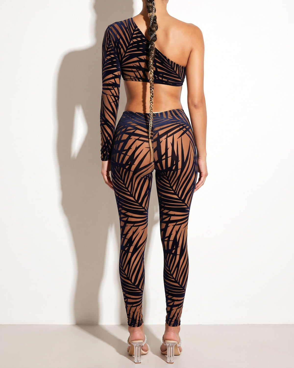 Mocha and navy tropical leaf silhouette one sleeve jumpsuit, back view on model