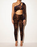 Muvin women's mocha and navy tropical leaf silhouette one sleeve jumpsuit, front view on model
