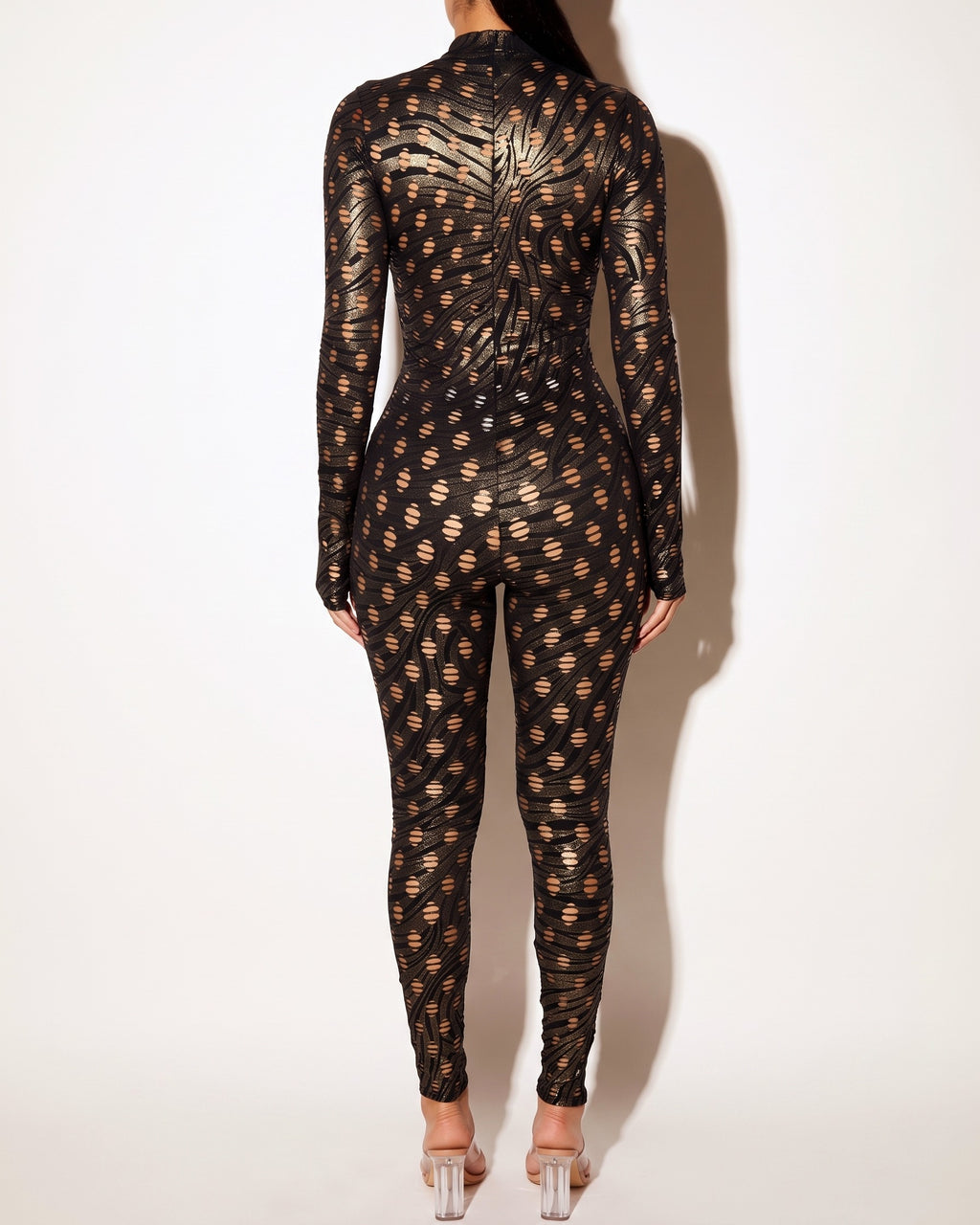 Gold and black foiled hole novelty jumpsuit, back view on model