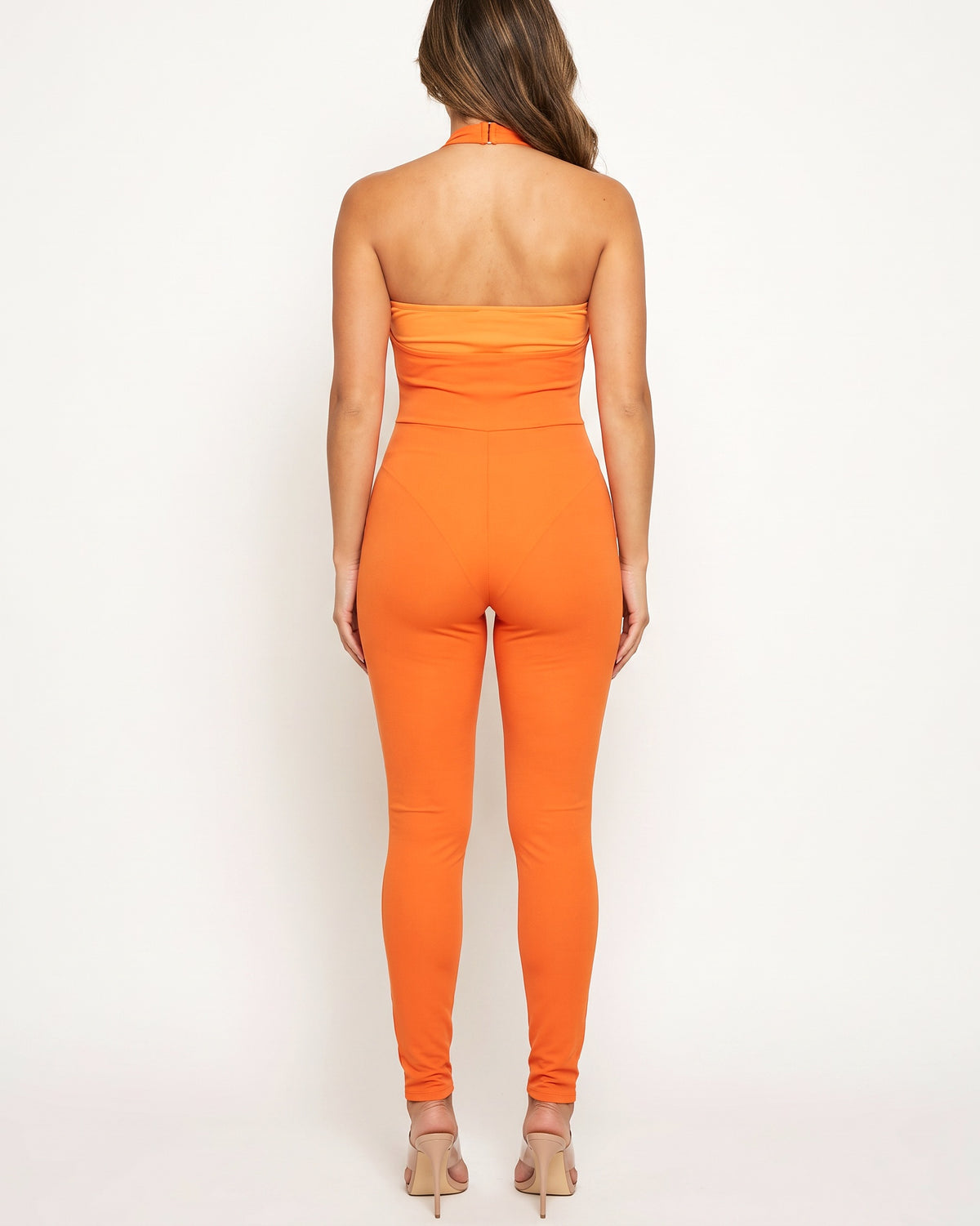 Orange hollow up novelty knit leg cutout jumpsuit, back view on model