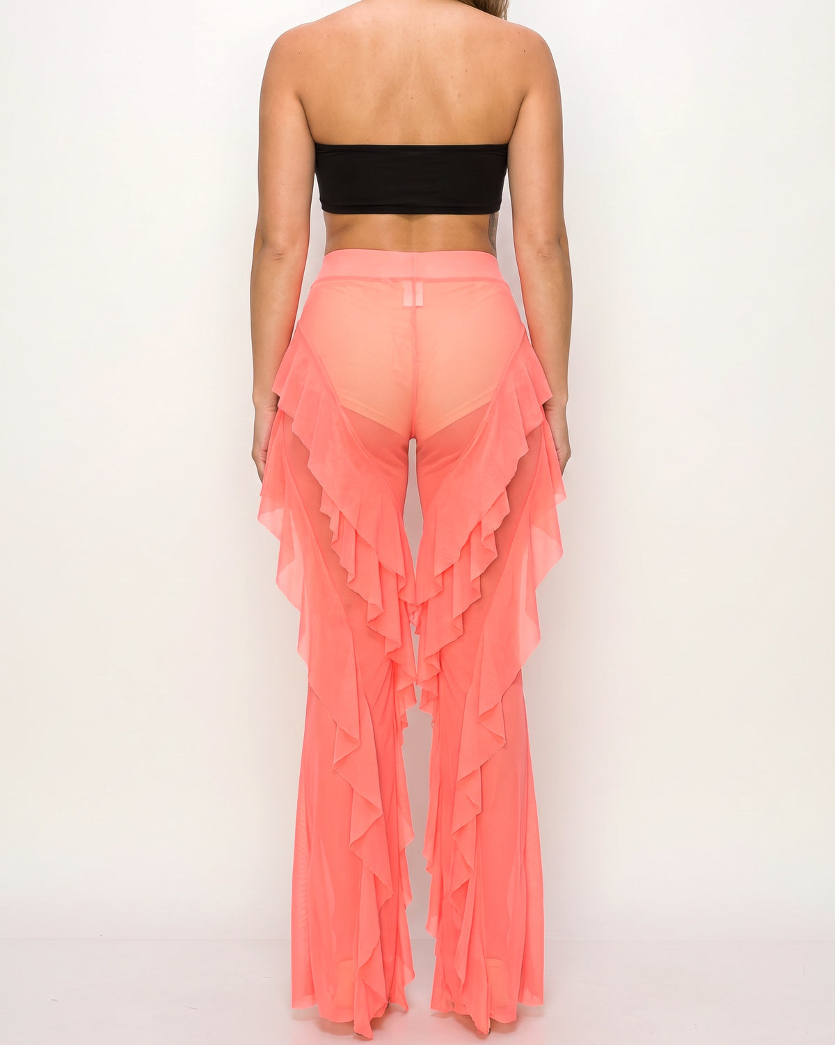 Neon coral ruffled mesh cover up pants, back view on model