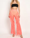 Muvin women's neon coral ruffled mesh cover up pants, front view on model