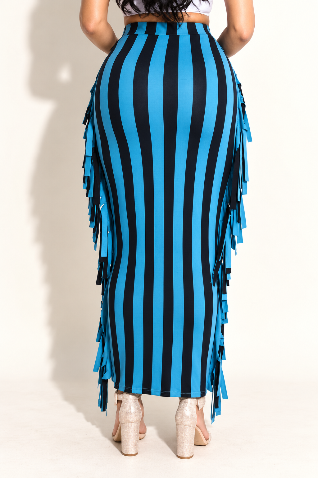 Denim blue and black striped fringe maxi skirt, rear view showing continuous vertical stripes and side fringe