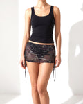 Black glitter mesh low rise ruched micro mini skirt, front view on model