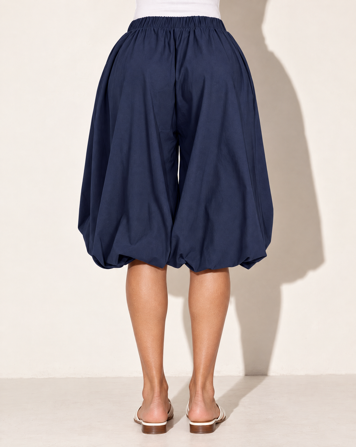 Wide Bubble Hem Capri Pants in Navy — back view
