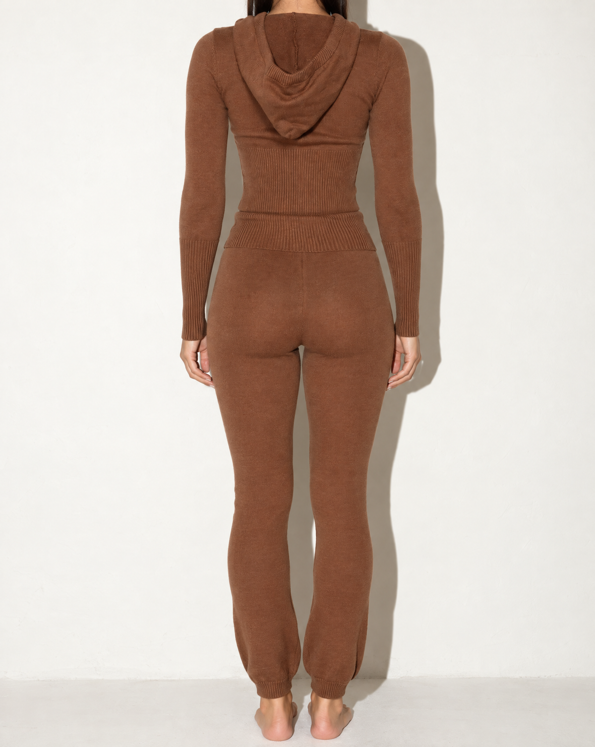 Brown hoodie zip up top and pants set, back view on model