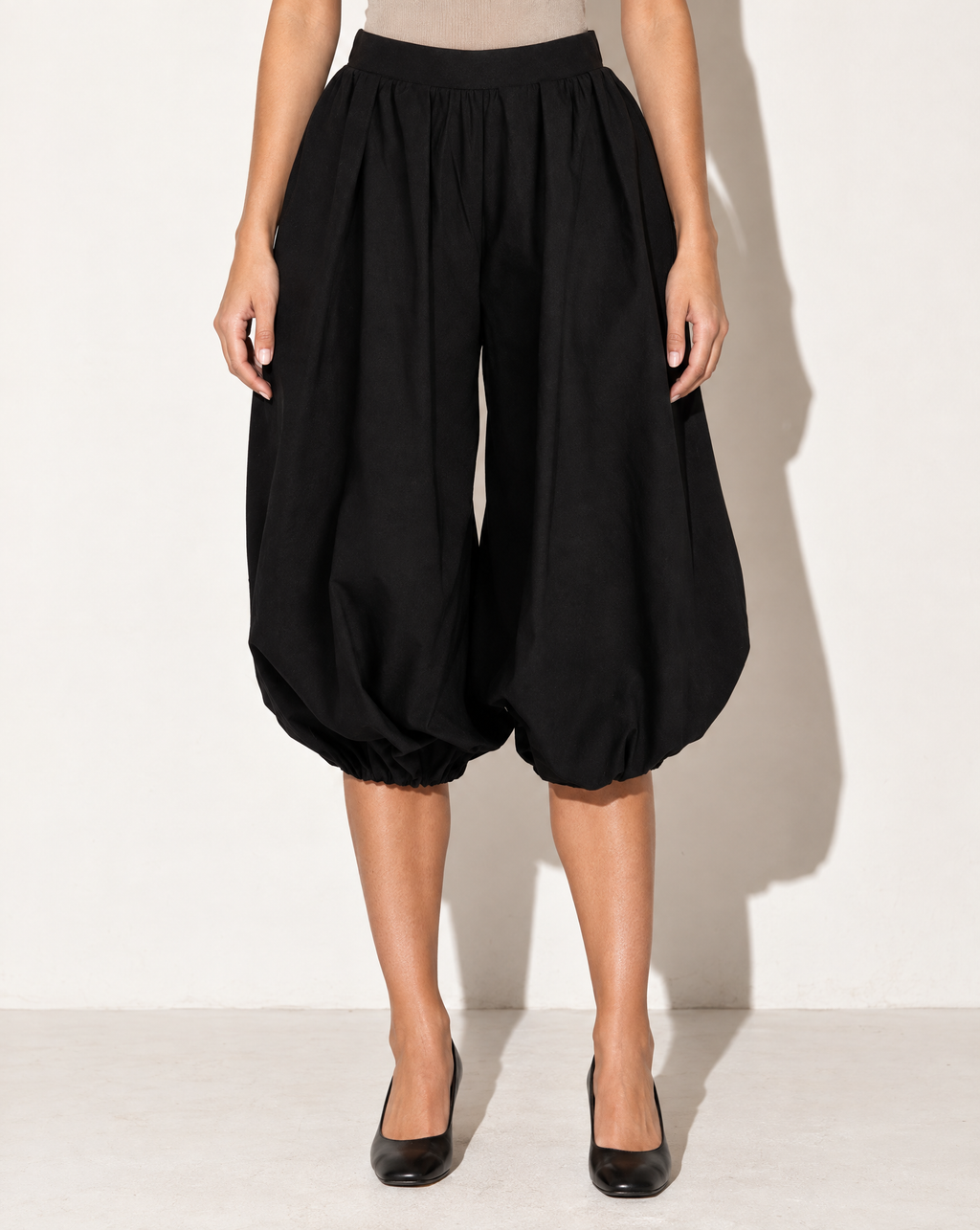 Wide Bubble Hem Capri Pants in Black — front view