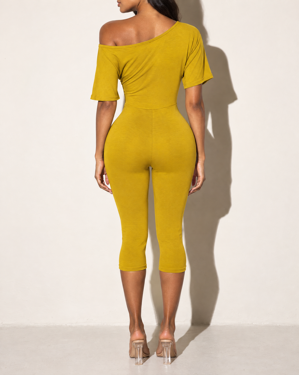 One Off Shoulder Capri Jumpsuit in Mustard — back view