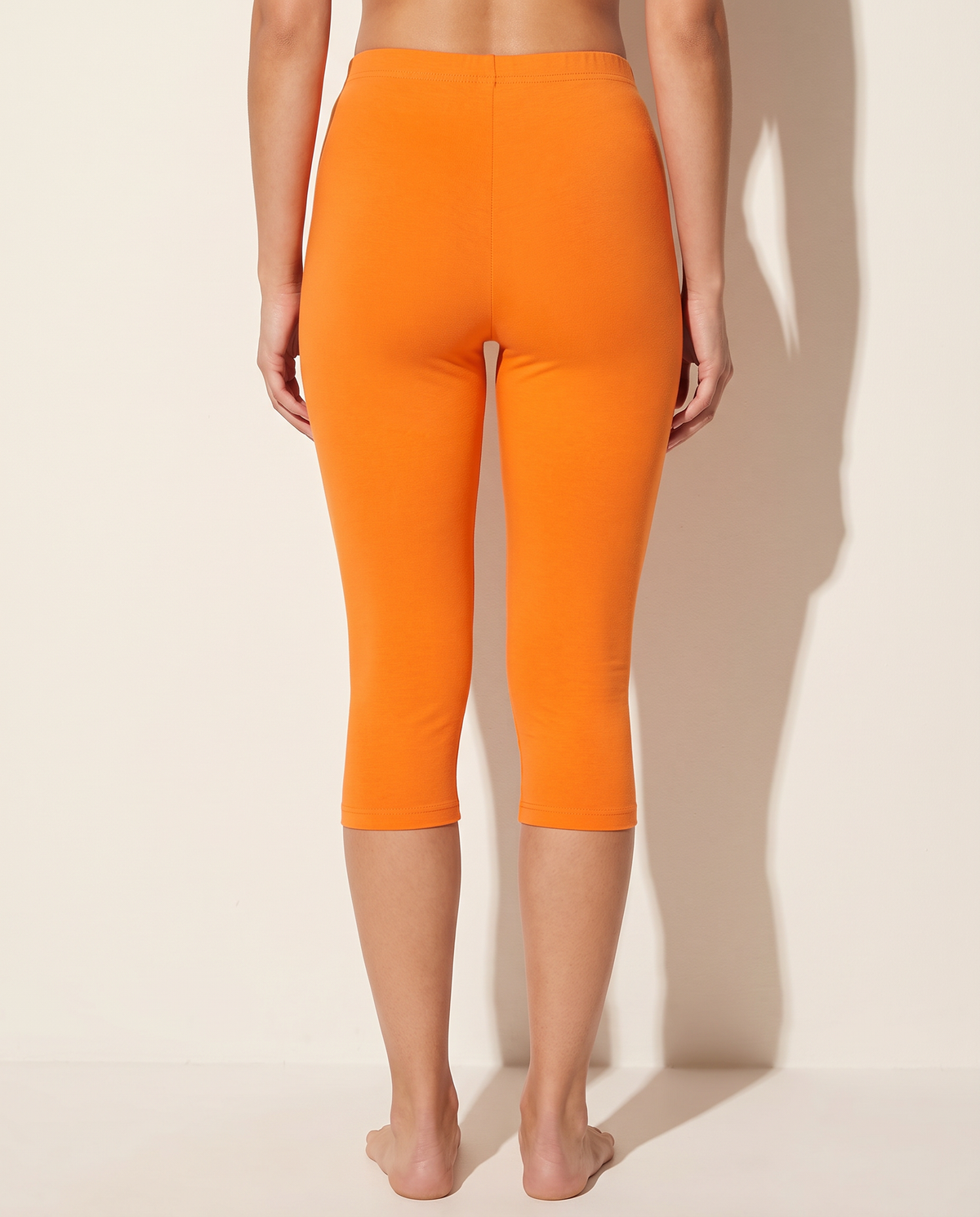 Elevated Basic Solid Capri Leggings in Orange — back view
